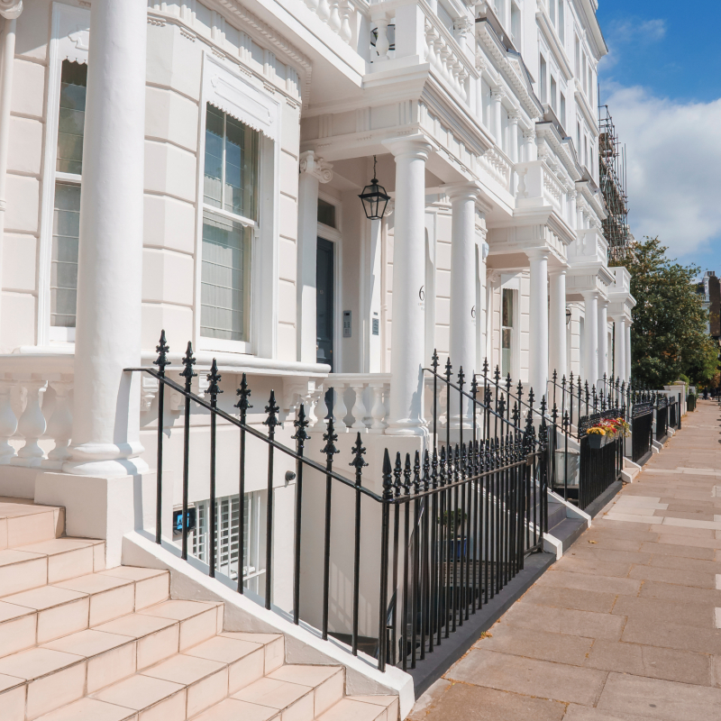 Steps of luxurious property in Pembridge Gardens. Residential house by footpath. Apartment in London on sunny day.